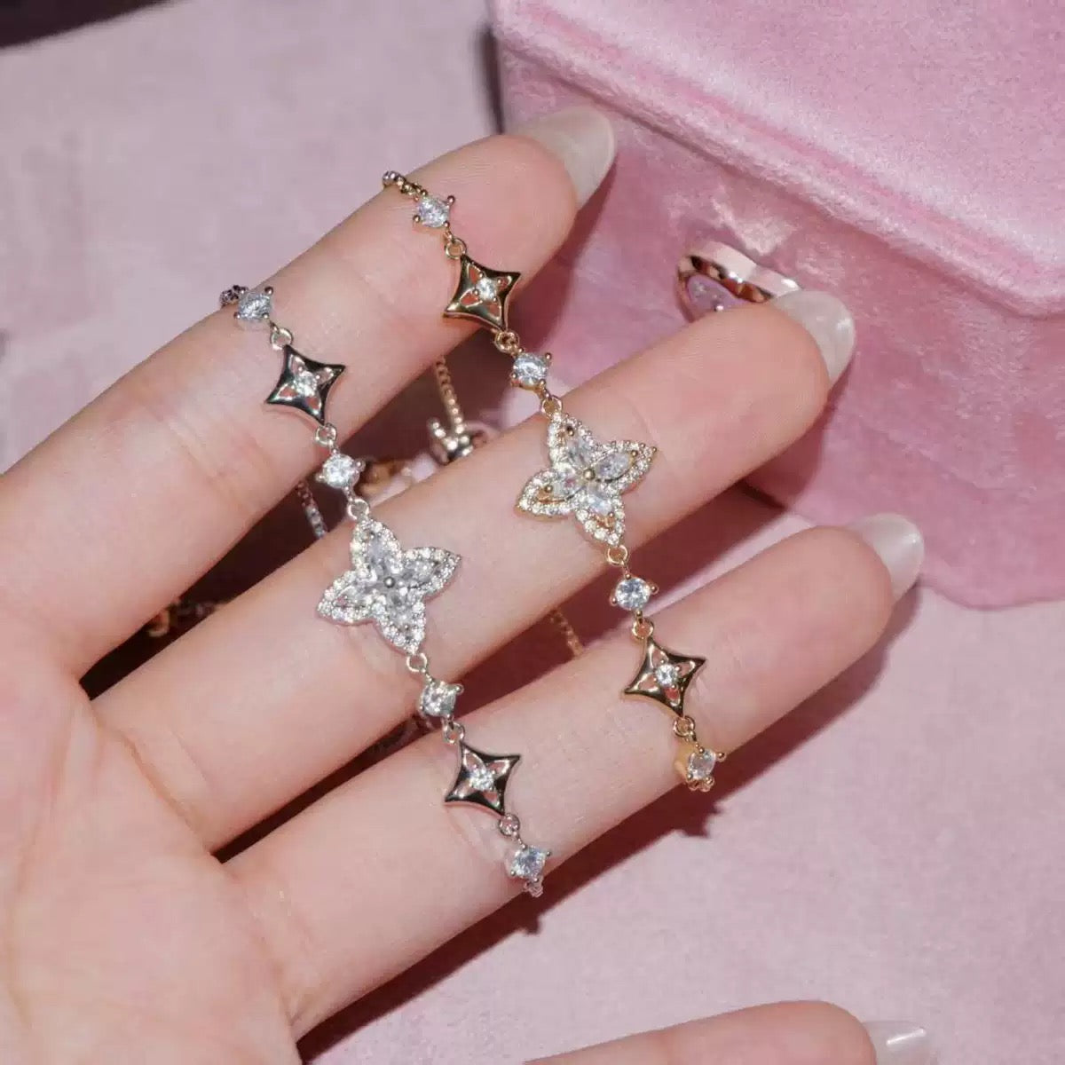 Iris Bloom Zircon Bracelet in gold-tone metal, with sparkling clear stones, floral blooms and star-shaped links.