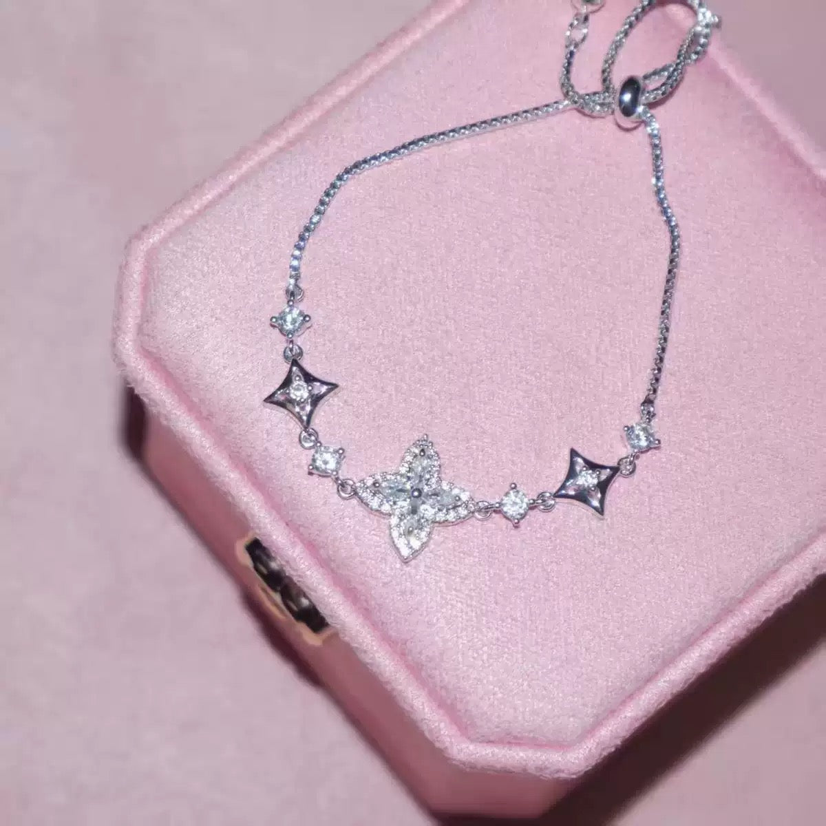 Iris Bloom Zircon Bracelet in silver-tone metal, with sparkling clear stones and a central floral motif flanked by star accents.